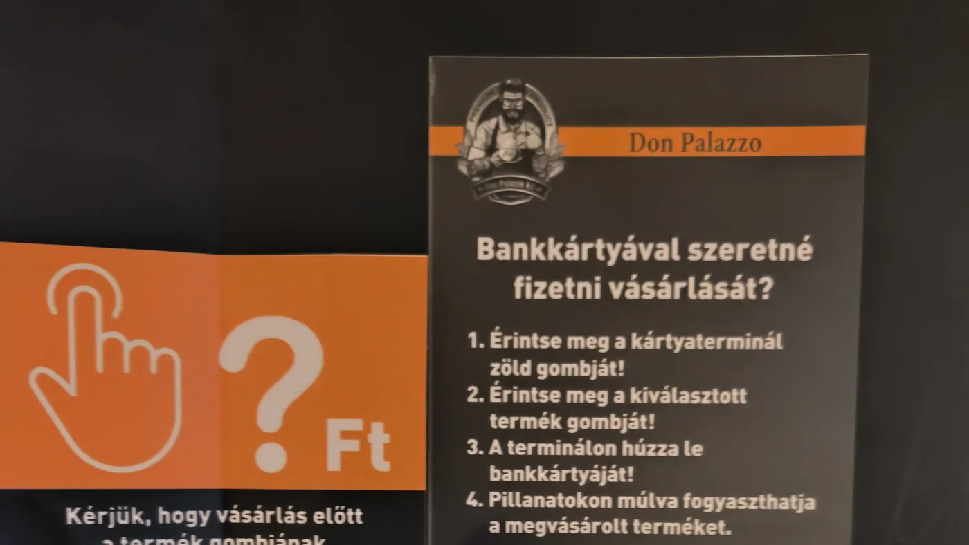 A coffee vending machine with Hungarian instructions for paying by bank card and a card terminal